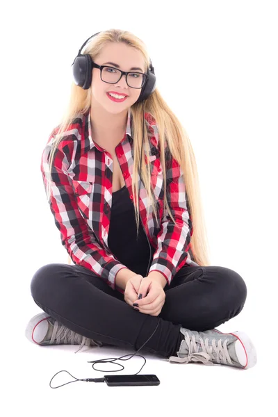 Young happy blondie woman listening music in headphones isolated — Stock Photo, Image