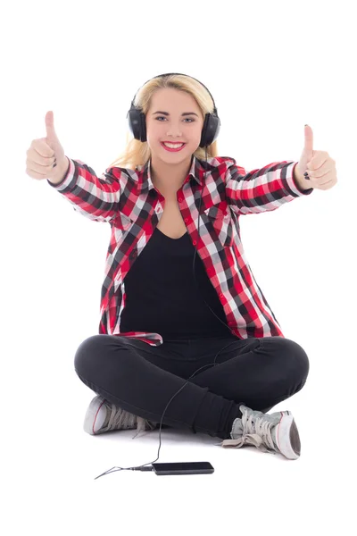 Glad tonårig flicka lyssna musik i hörlurar och tummen upp är — Stockfoto