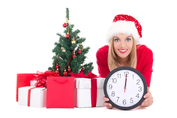 Woman lying down with clock, christmas tree and gifts isolated o — Stock Photo, Image