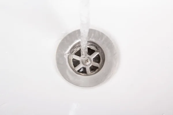 Bath water flows into the drain — Stock Photo, Image