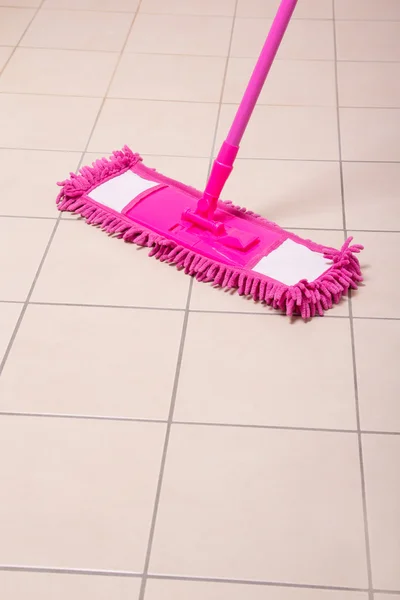 Mopping tile floor in light bathroom — Stock Photo, Image