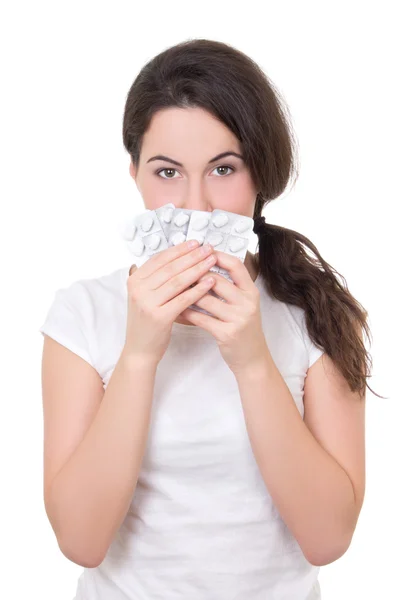 Young brunette woman showing blister of pills isolated on white — Stock Photo, Image