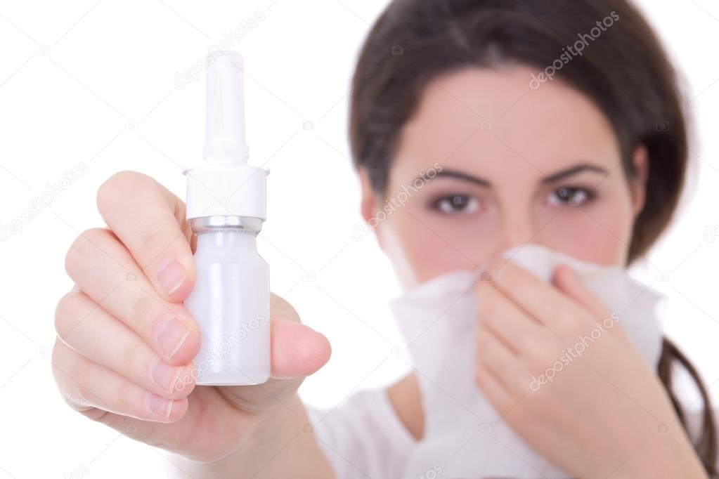 attractive young woman holding nasal spray isolated on white