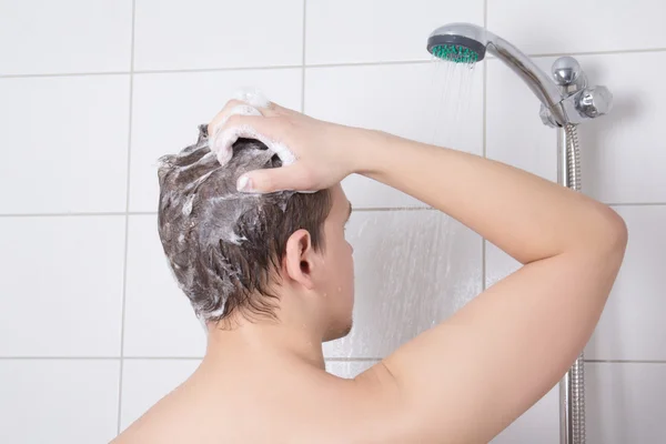 Back view of young attractive man having a shower — Stock Photo, Image