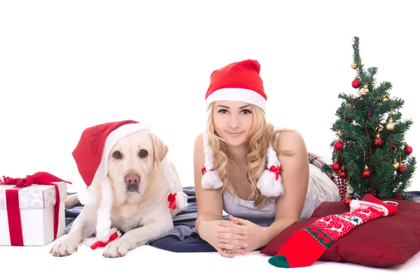 Pretty teenage girl in pajamas lying with dog in santa hat isola — Stock Photo, Image