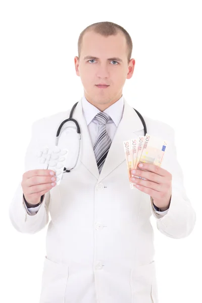 Joven guapo doctor con el paquete de píldoras y los billetes en euros i — Foto de Stock