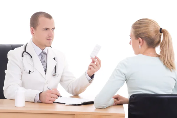 Young male doctor giving pills to patient isolated on white — Stock Photo, Image