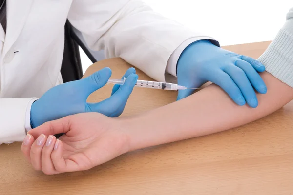 Close up of doctor giving an injection to woman Stock Photo