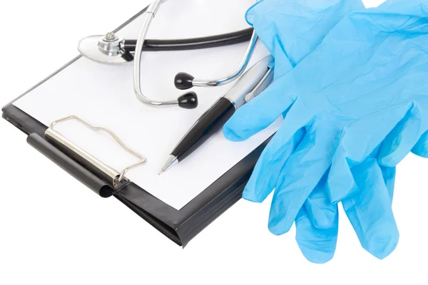 Close up of plastic clipboard, pen, rubber gloves and stethoscop — Stok Foto