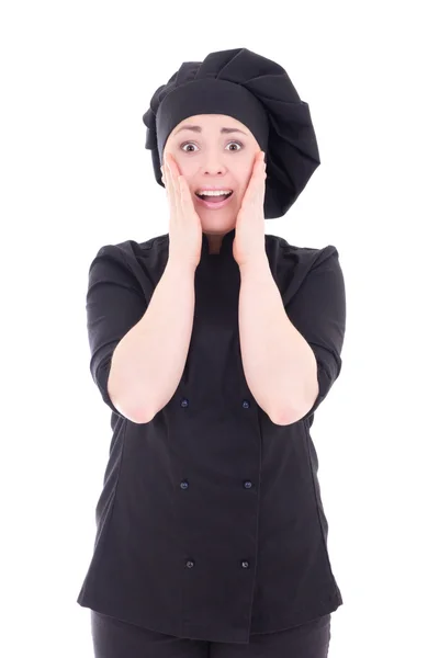 Возбужденные молодые повар женщина в черной форме, изолированные на белом — стоковое фото