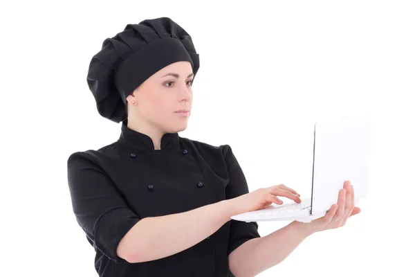 Young chef woman in black uniform with laptop isolated on white — Stock Photo, Image