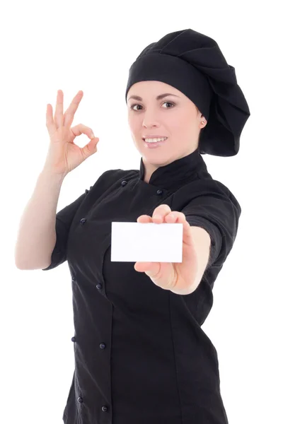 Young chef woman in black uniform showing visiting card isolated — Stok Foto