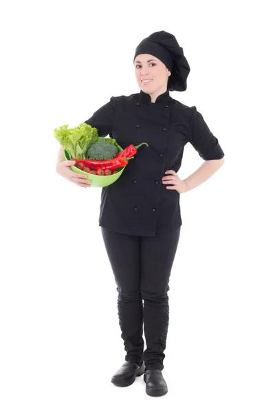 Молодые привлекательные готовить женщину в черной униформе с овощами iso — стоковое фото