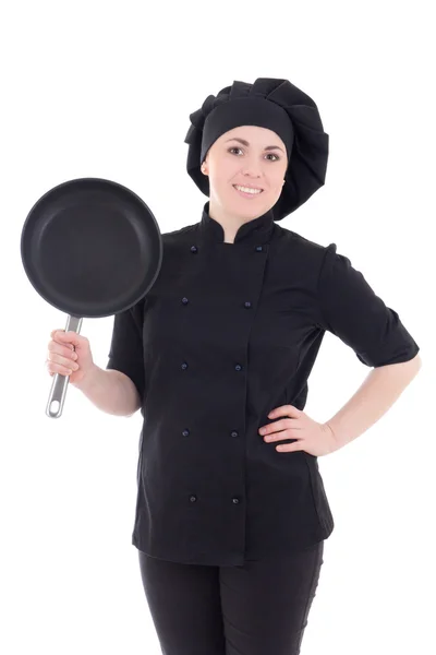 Jonge vrouw in het zwart uniforme koken met koekenpan geïsoleerd op wh — Stockfoto