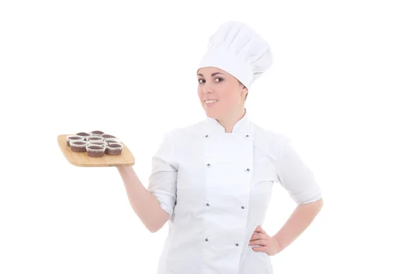 Young attractive cook woman in uniform with chocolate muffins is — Stock Photo, Image