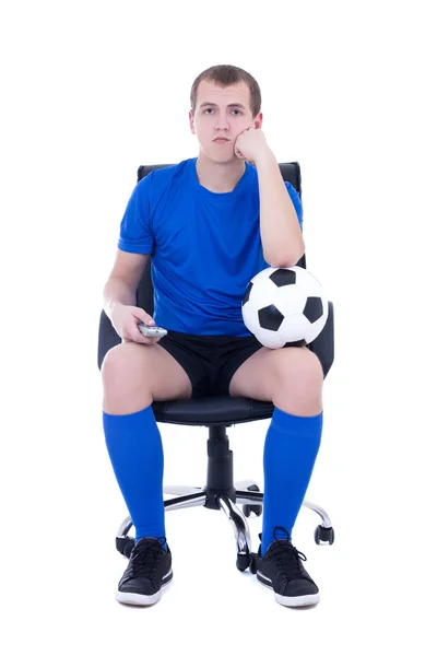 Hombre aburrido en uniforme sentado con control remoto y viendo así —  Fotos de Stock