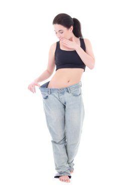genç güzel ince heyecanlı kadın büyük Jeans ile izole üzerinde
