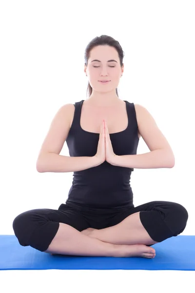 Young woman sitting in lotus position on fitness mat isolated on — Stock Photo, Image