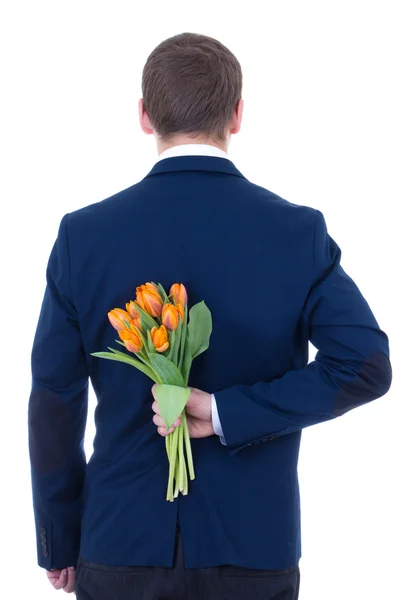 Homem escondido o buquê de flores nas costas isolado no branco — Fotografia de Stock