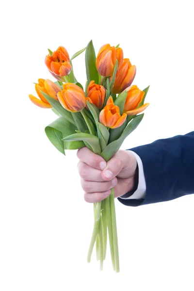 Bos van oranje bloemen in mannenhand geïsoleerd op wit — Photo