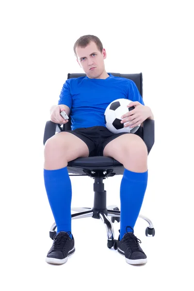 Bored man in uniform with remote control watching soccer game is — Stock Photo, Image