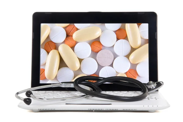 Laptop mit Tabletten auf dem Bildschirm, die isoliert auf weiss — Stockfoto