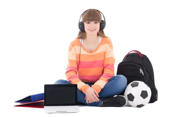 Sitting teenage girl listening music in headphones isolated on w — Stock Photo, Image