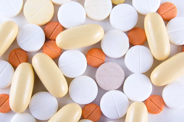 Colorful pills and capsules over white — Stock Photo, Image