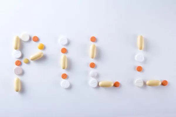 Pill word text made of colorful tablets, pills and capsules — Stock Photo, Image