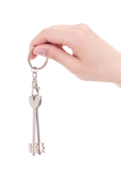 Woman hand holding keys isolated on white — Stockfoto