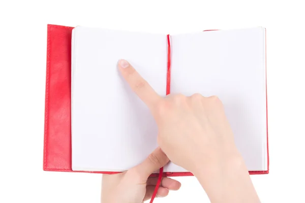 Mujer mano apuntando en cuaderno en blanco aislado en blanco — Foto de Stock