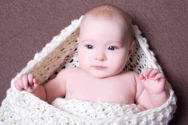 Portrait of beautiful baby girl in white woolen scarf — Stock Photo, Image