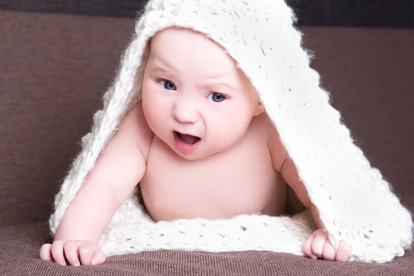 Funny baby girl in white woolen scarf crawling — Stock Photo, Image