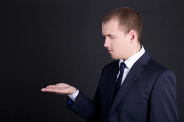 Business man showing something on his hand — Stock Photo, Image
