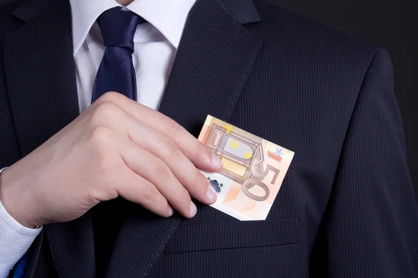 Business man hand sätta eurosedel i kostym pocket — Stockfoto