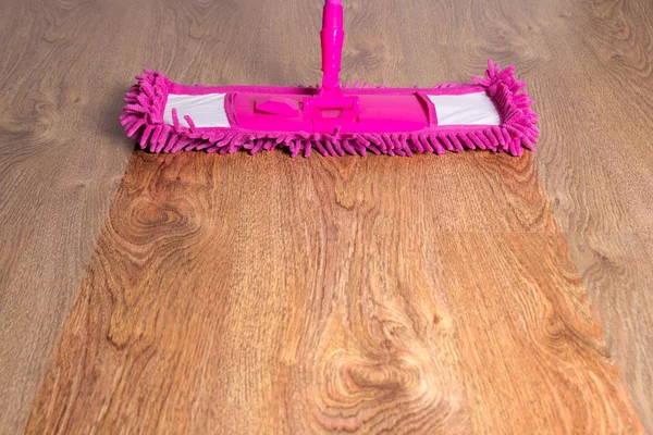 Close up of wooden floor with pink mop - before after — Stock Photo, Image