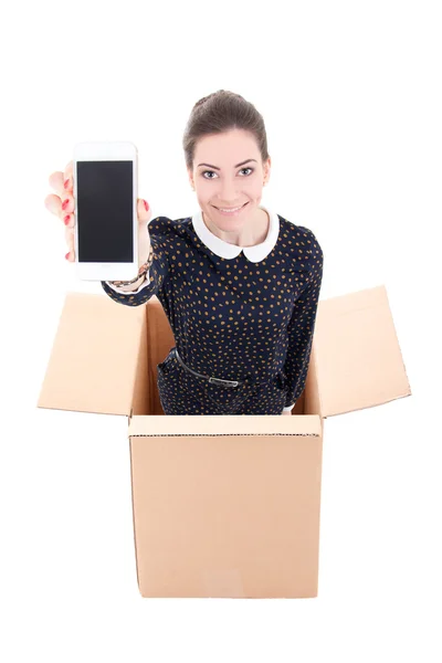 Delivery - woman in cardboard box holding mobile phone with blan — Stock Photo, Image