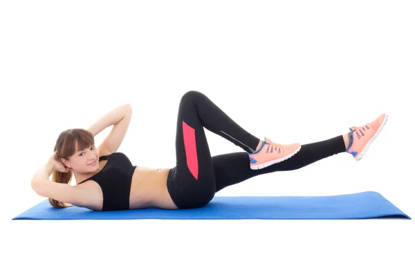 Mujer joven haciendo ejercicios para la musculatura abdominal aislado en wh —  Fotos de Stock