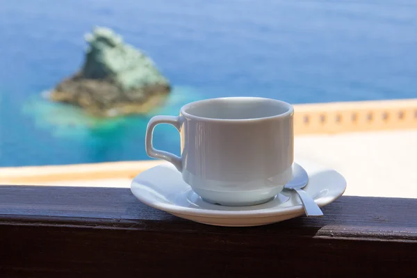 Cup of coffee on balcony with sea view — Stock Photo, Image