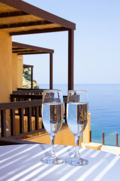 Glasses of champagne on balcony with sea view — Stock Photo, Image