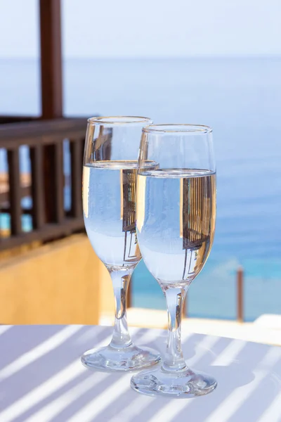 Glasses of champagne on terrace with sea view — Stock Photo, Image