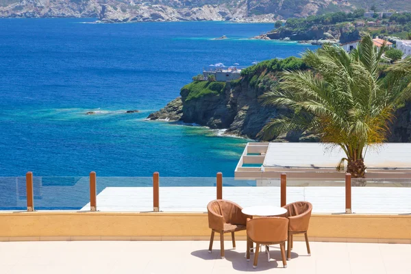 Table and chairs on terrace with sea view — Stock Photo, Image