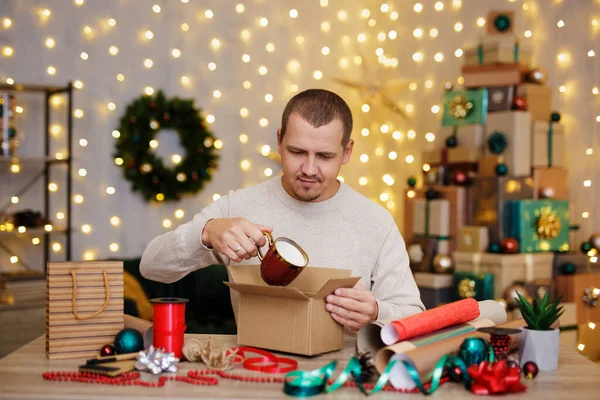 Portrait Young Man Wrapping Christmas Present Home — Stok Foto