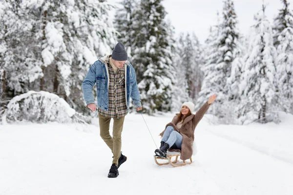 Young Handsome Man Pulling Sledge His Joyful Girlfriend Winter Day — Stock Photo, Image