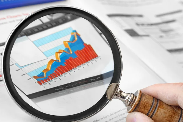 Magnifying Glass Over Financial Graph — Stock Photo, Image