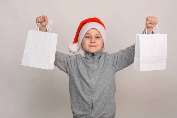 An 8-10-year-old boy in a Santa helper Christmas hat — Stock Photo, Image