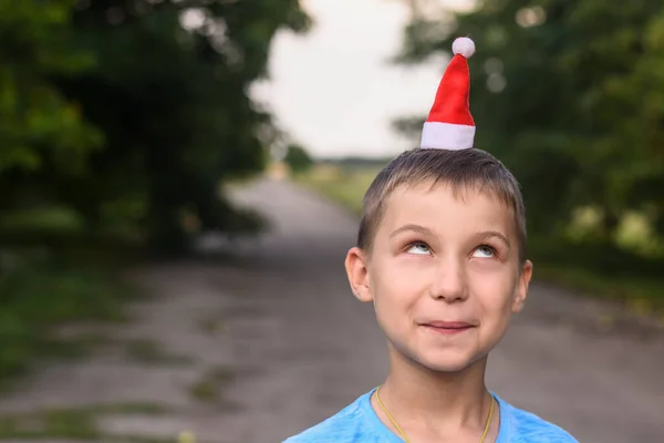 Funny boy put a little Santa hat on his head. mock up — Stock Photo, Image