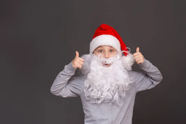 A surprised Santa boy gives a thumbs up. mock up — Stock Photo, Image