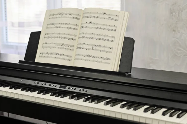 Piano keys, sheet music. electronic piano at a music school.