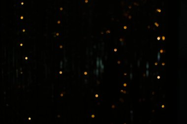 Altın parçacıklar, bokeh etkileri. koyu soyut doku arkaplanı